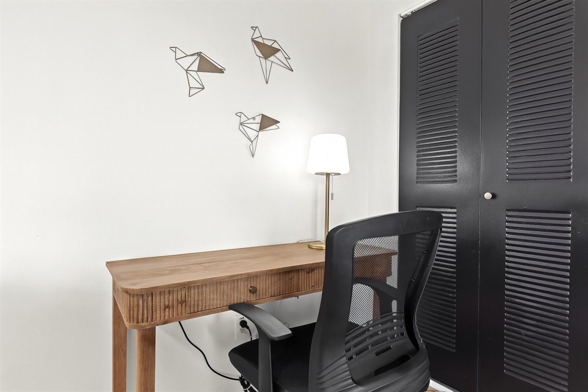 Thoughtfully designed workspace with wall-mounted lighting and a sleek writing desk for remote work or study.