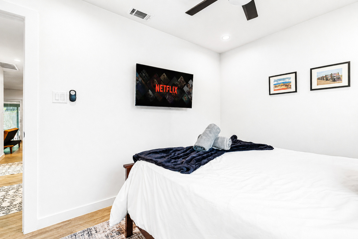 Enjoy movie nights with Netflix on the wall-mounted TV and plush bedding!