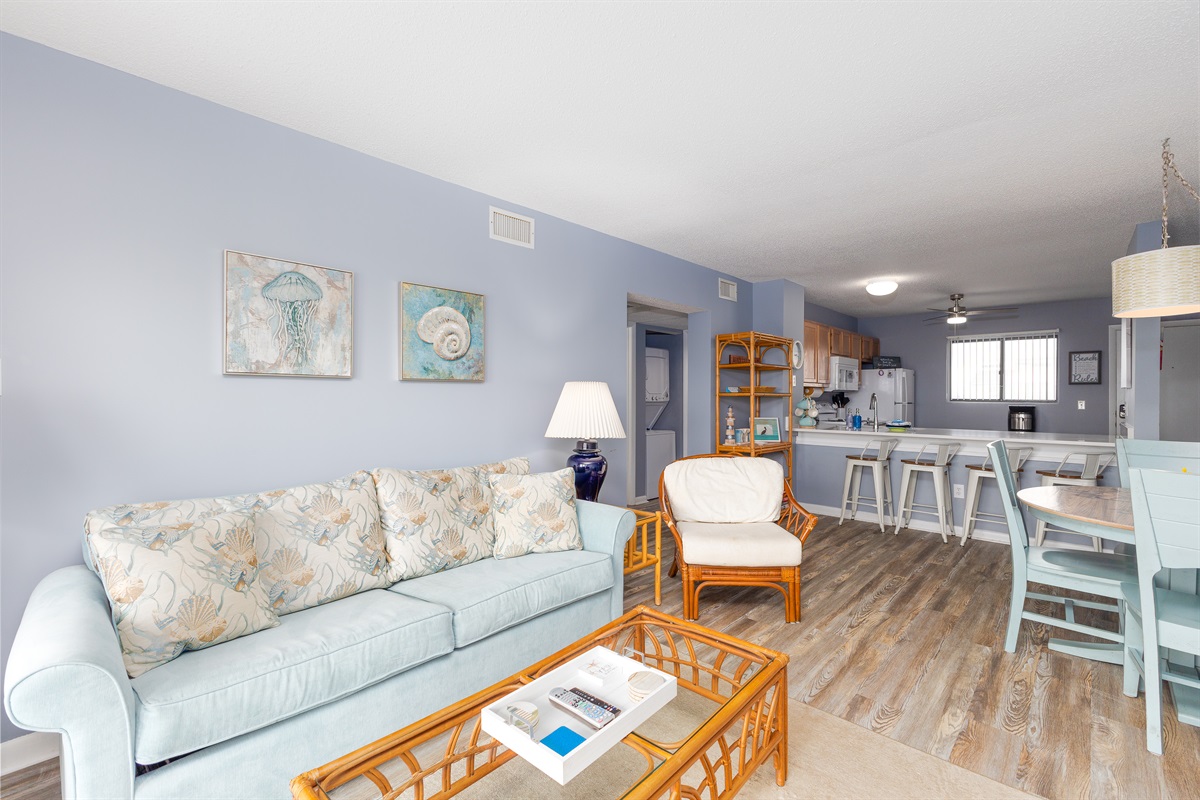 The living room transitions into the kitchen