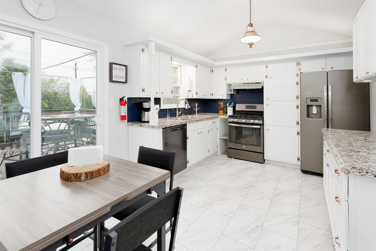 Spacious, light-filled kitchen featuring full-size appliances and generous counter space for everyday cooking.