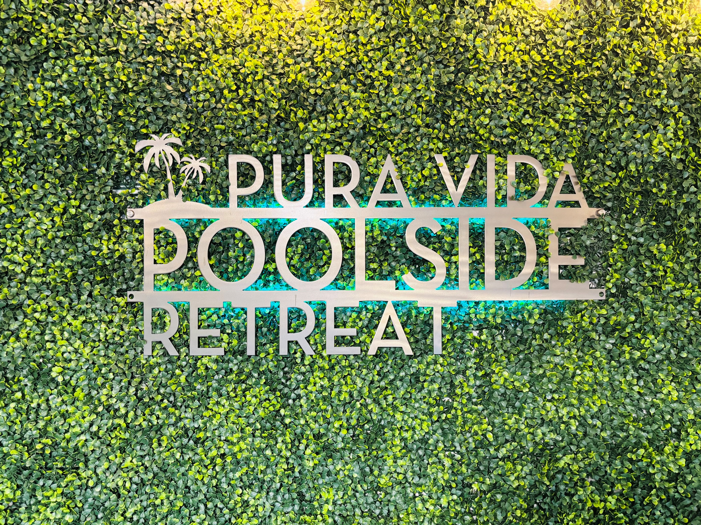 Pura Vida Poolside Retreat sign