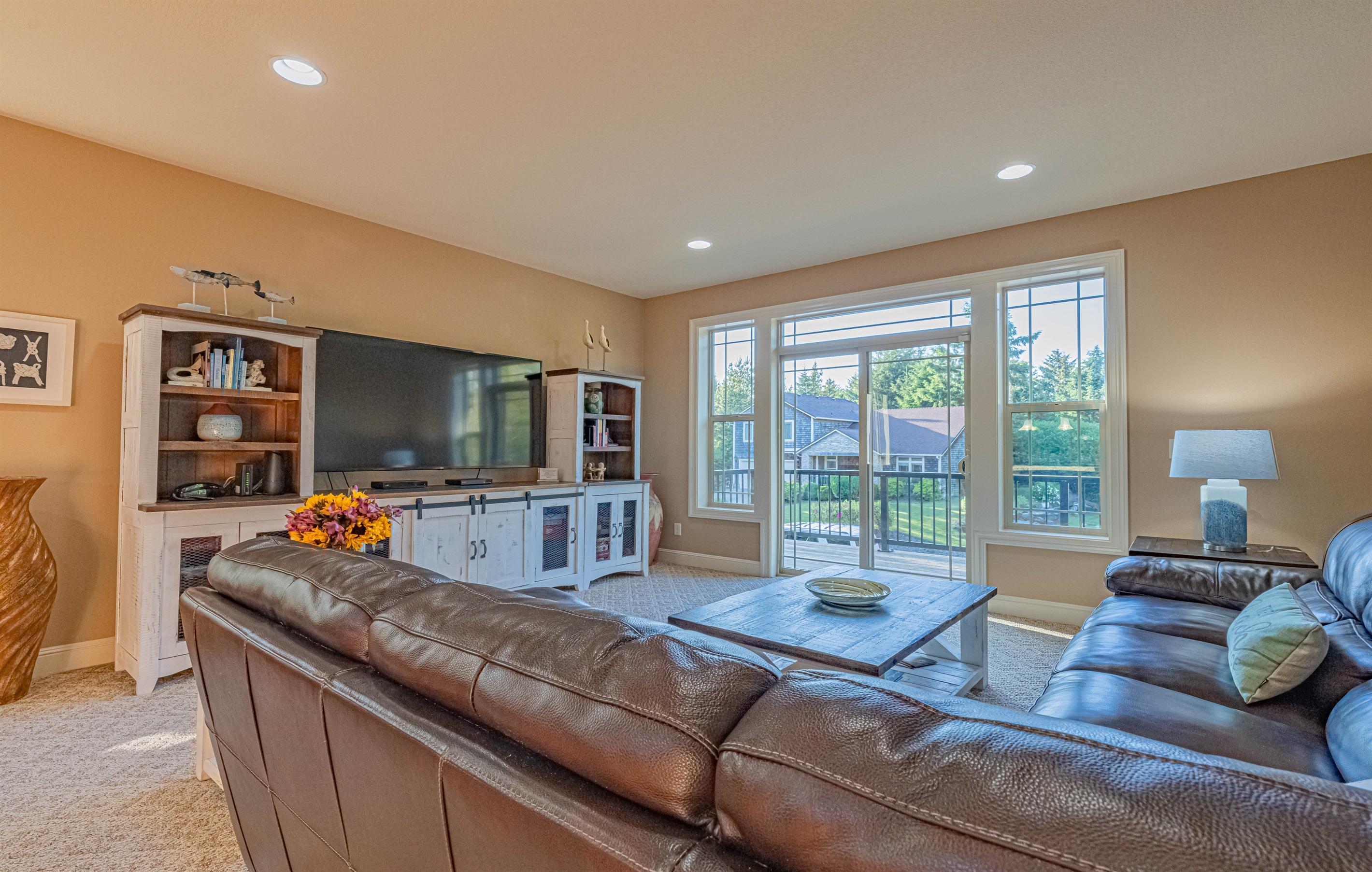 Comfy family room off kitchen.  Leather sectional sofa, 75" TV w/cable, DVD player w/movies.