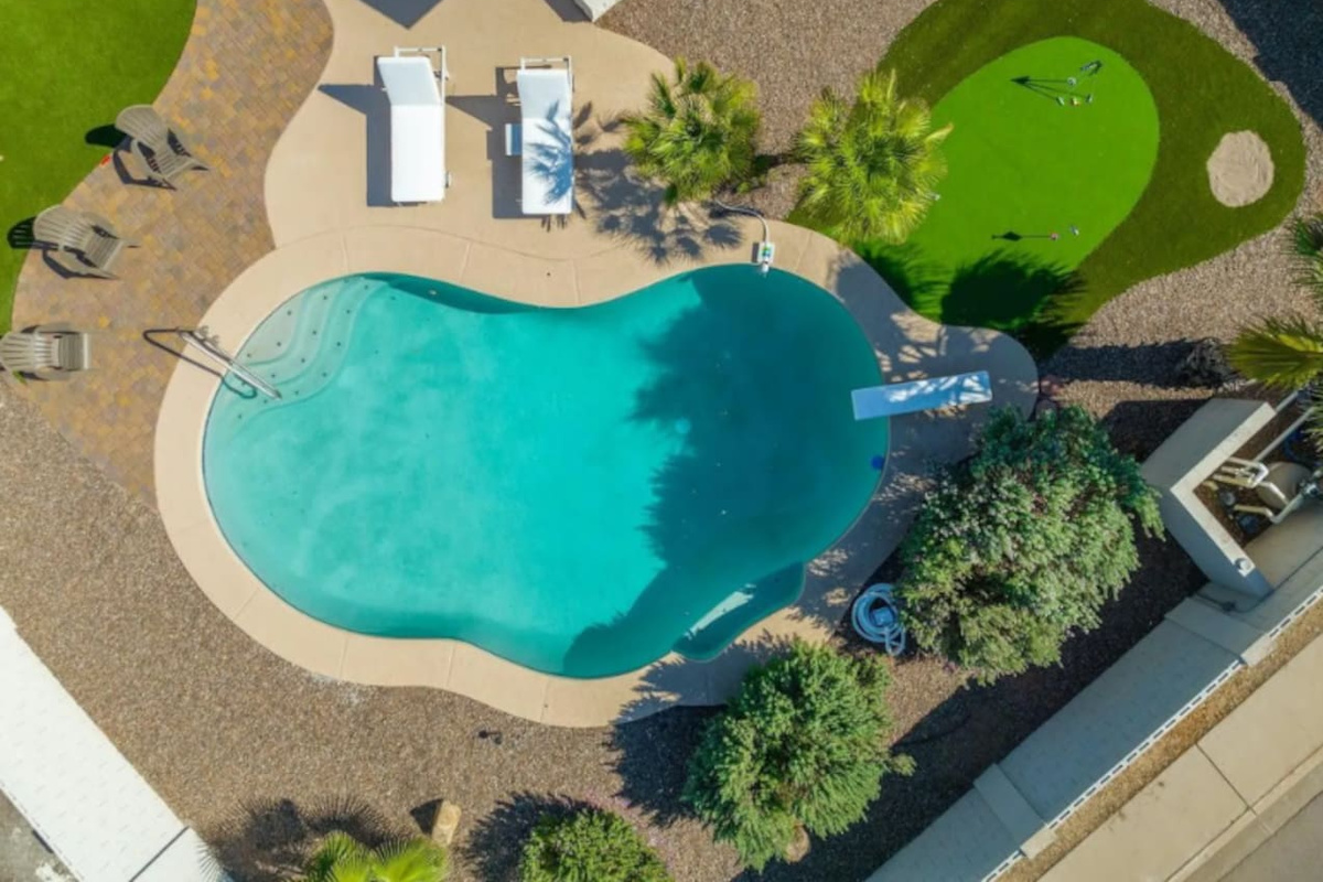 Sparkling lagoon-style pool with lounging areas, putting green, and resort-quality amenities.