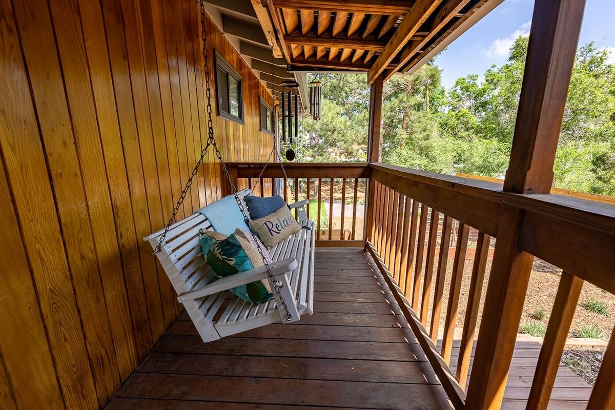 Covered porch swing overlooking the side yard 