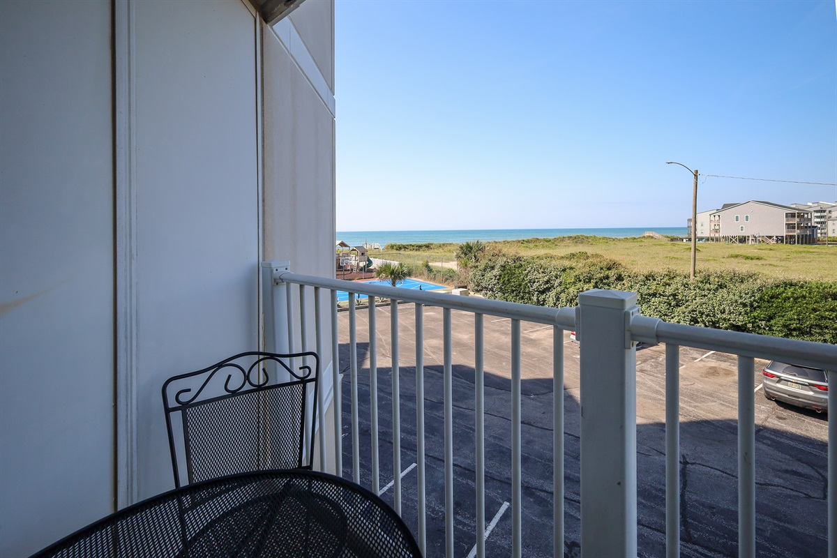 Sunny day, inviting balcony overlooking the ocean!