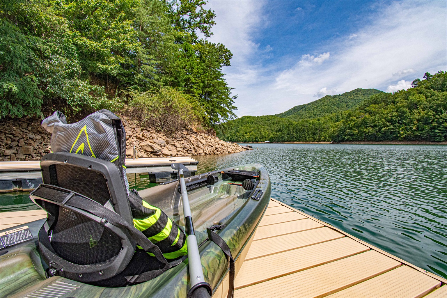 Lakefront Adventure: Launch your kayak from the dock and explore stunning mountain views!