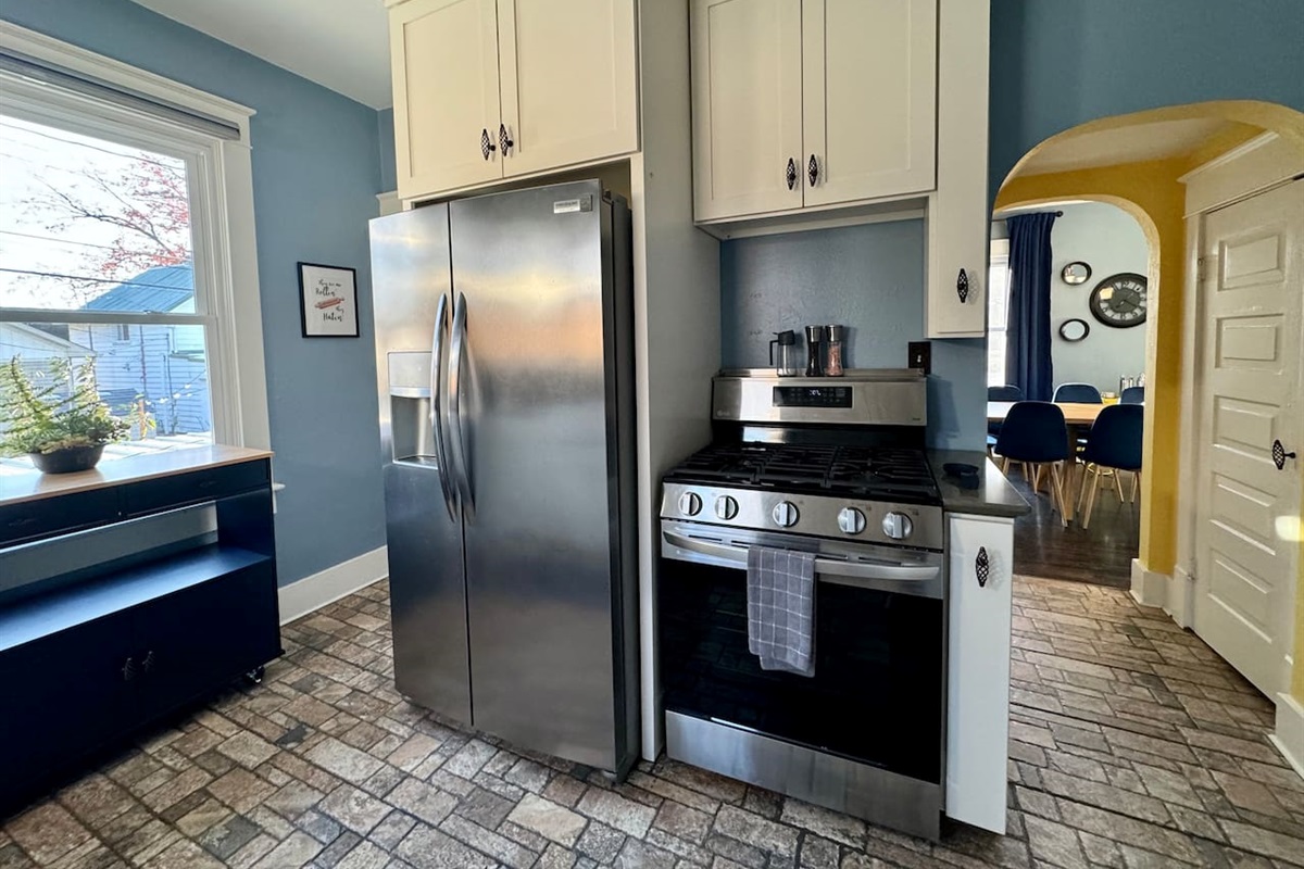 The Main Level Kitchen offers Full size side-by-side refrigerator and range, pantry, and easy access to the Dining Room.