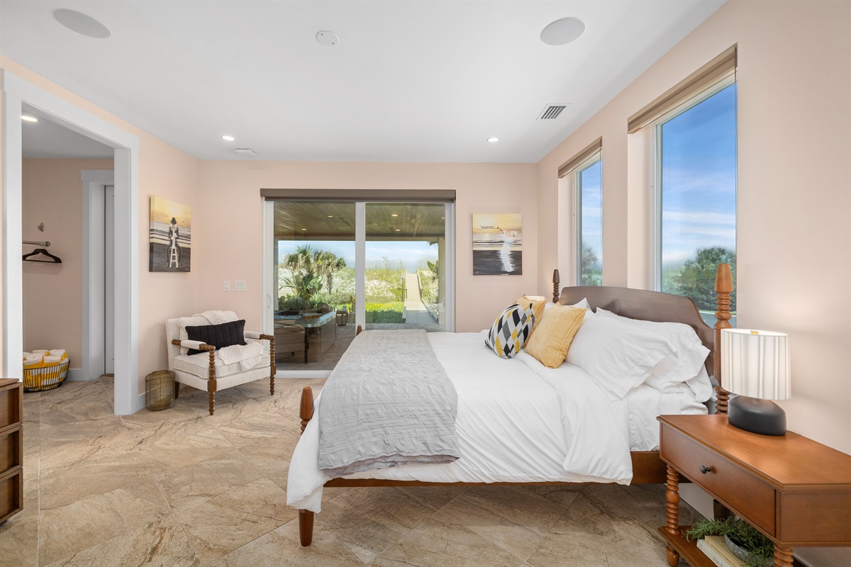 Inviting guest bedroom with covered porch with access to hot tub and beach