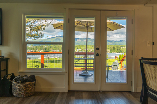 Relax inside and take in sweeping lake and mountain views right from the comfort of the couch. Large windows bring the outdoors in, making it easy to unwind, watch the water, and enjoy the scenery in every season.
