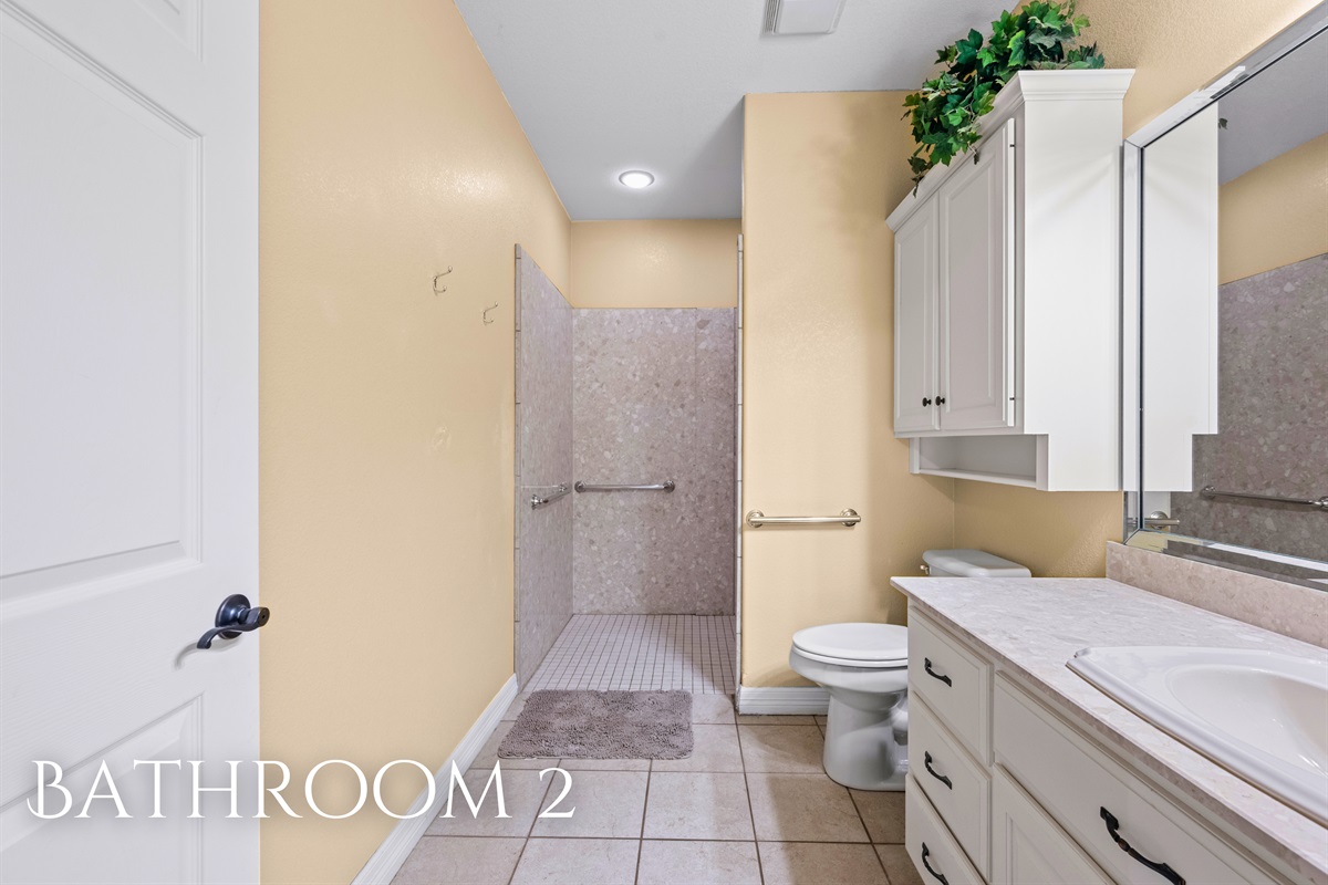 Bathroom 2 with dual sinks and walk-in shower.