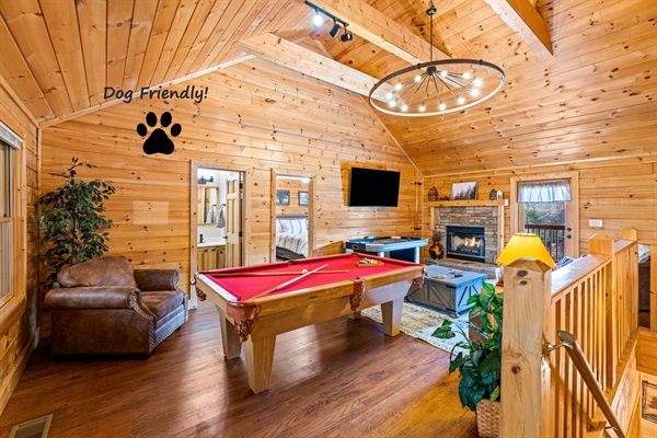 Game loft with pool table, air hockey, arcade game, and big screen TV