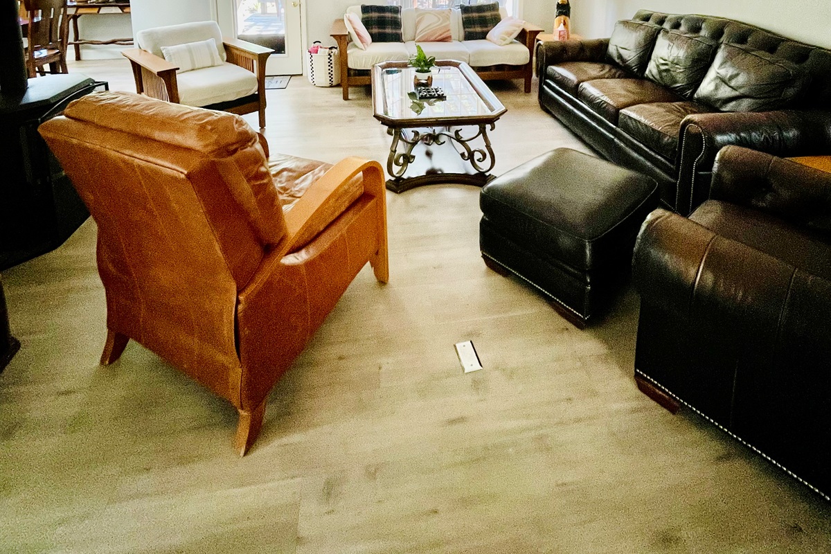 Embrace the cozy charm of our living room with a crackling fireplace, nestled in our inviting open floor plan. Perfect for gathering, relaxing, and making memories