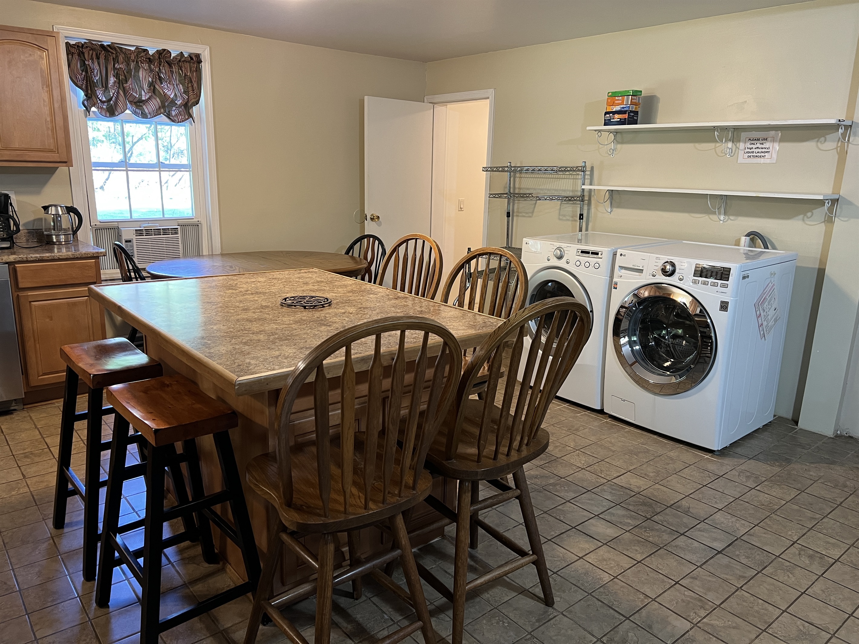 Laundry in the kitchen. The door to the left is a full bathroom with shower.
