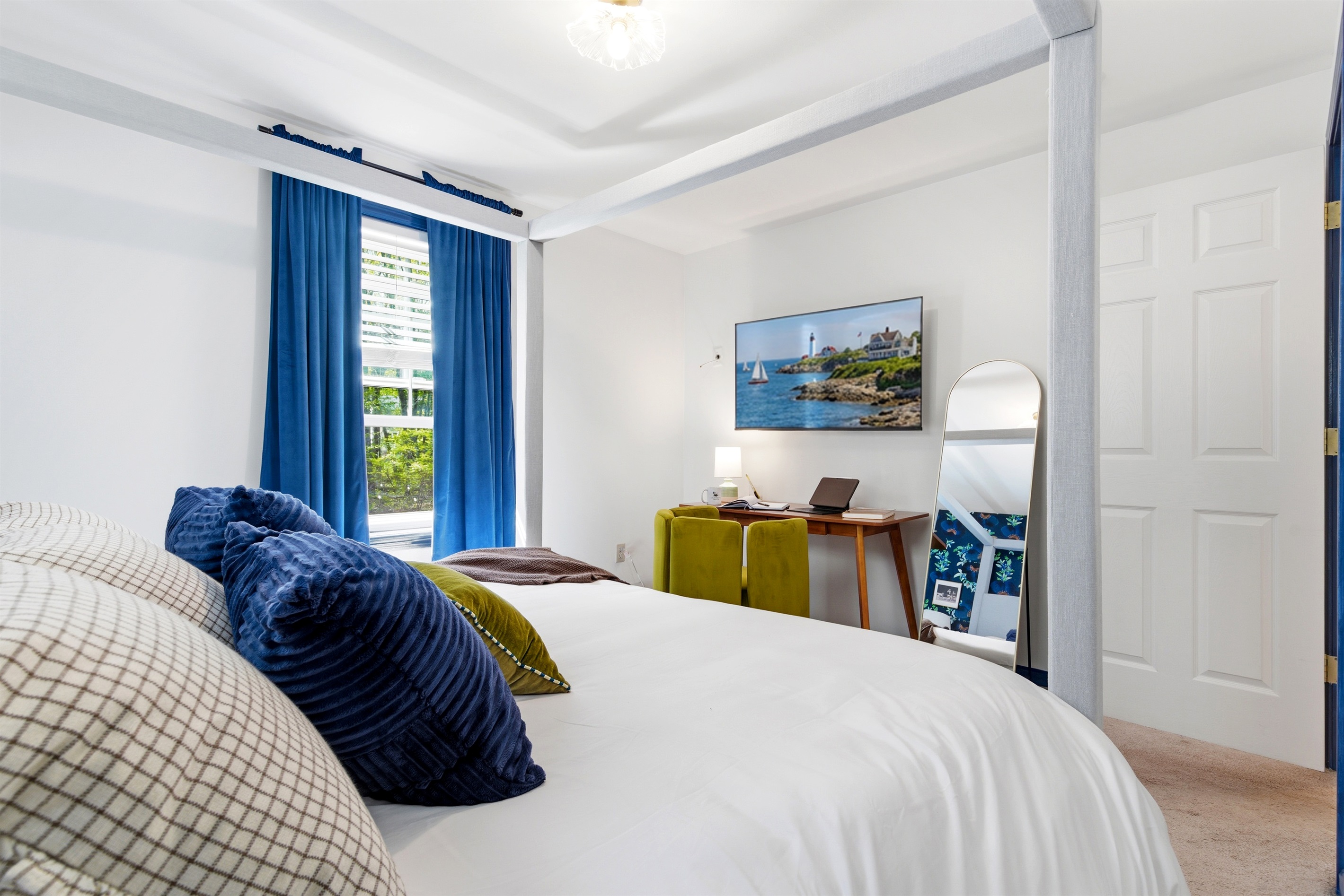 A well-appointed bedroom featuring a comfortable bed and a functional workspace, offering the perfect balance of rest and productivity in a calm, inviting setting.