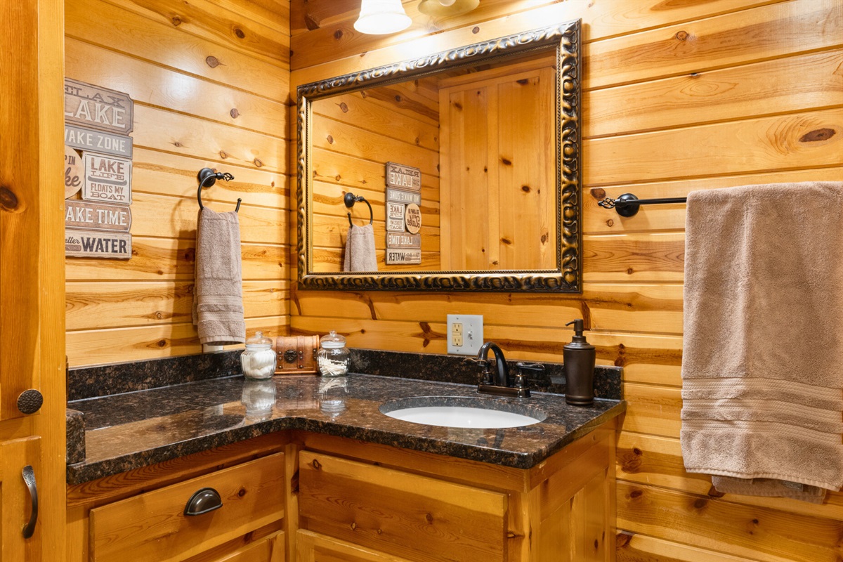 Granite vanity and cabin charm in Bathroom 1.