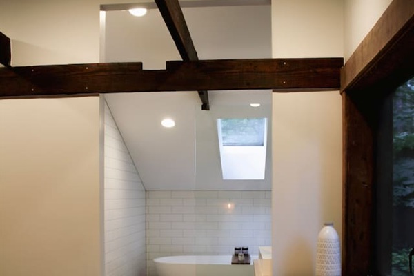 Spa like bathroom in master suite with full bathtub & shower wet room, infinity drain, floating wall mount toilet and vanity