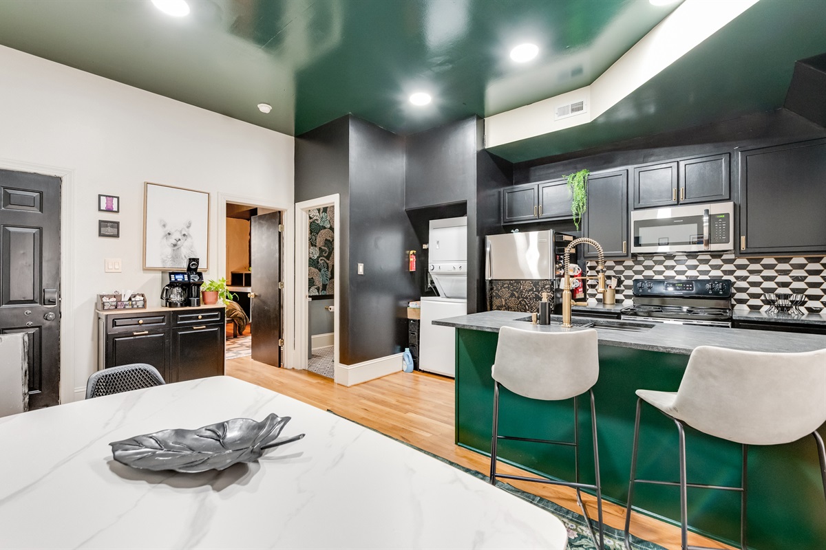 Kitchen: Dive into culinary adventures in this chic, modern space with striking black and green accents!