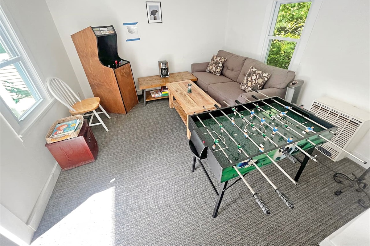 Fully stocked game room with foosball table, arcade games, and board games. 