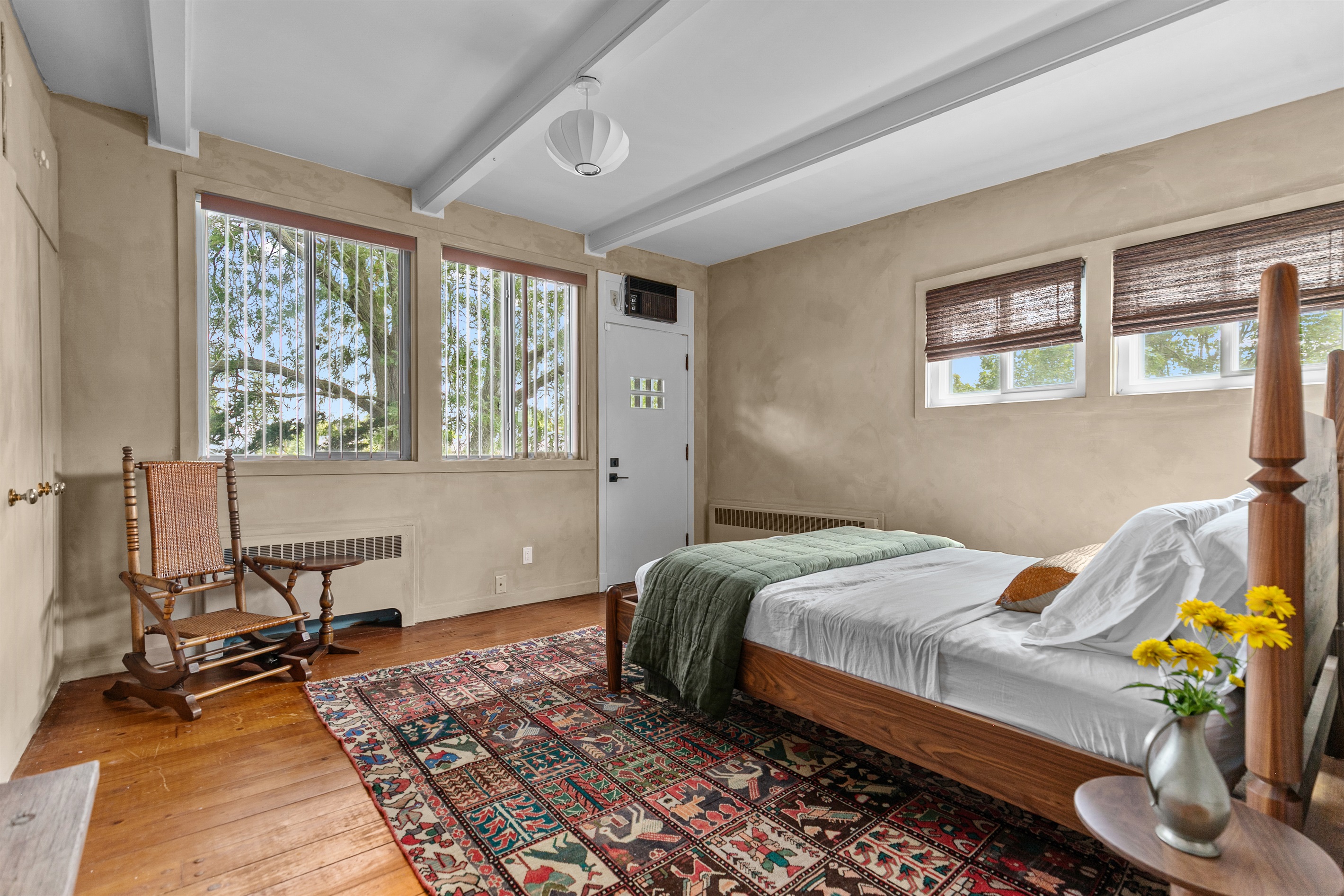 This Queen bedroom offers both comfort and convenience with its own exterior door leading to the balcony. Step outside for fresh air and backyard views, then return to the cool comfort of your personal air conditioning unit — a perfect retreat at any time
