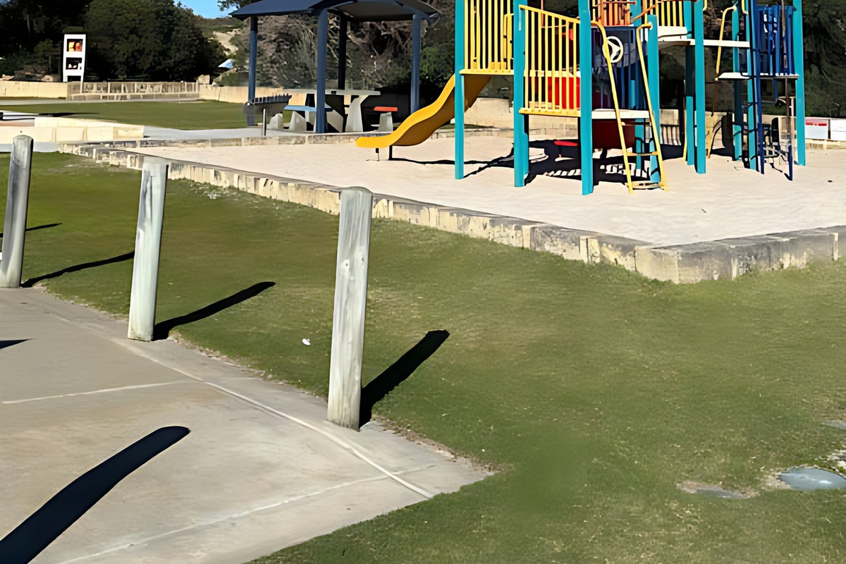 The Preston Beach foreshore playground has a climbing frame and slide, with a shaded picnic shelter and grassed area nearby, a short walk from the house close to the beach.