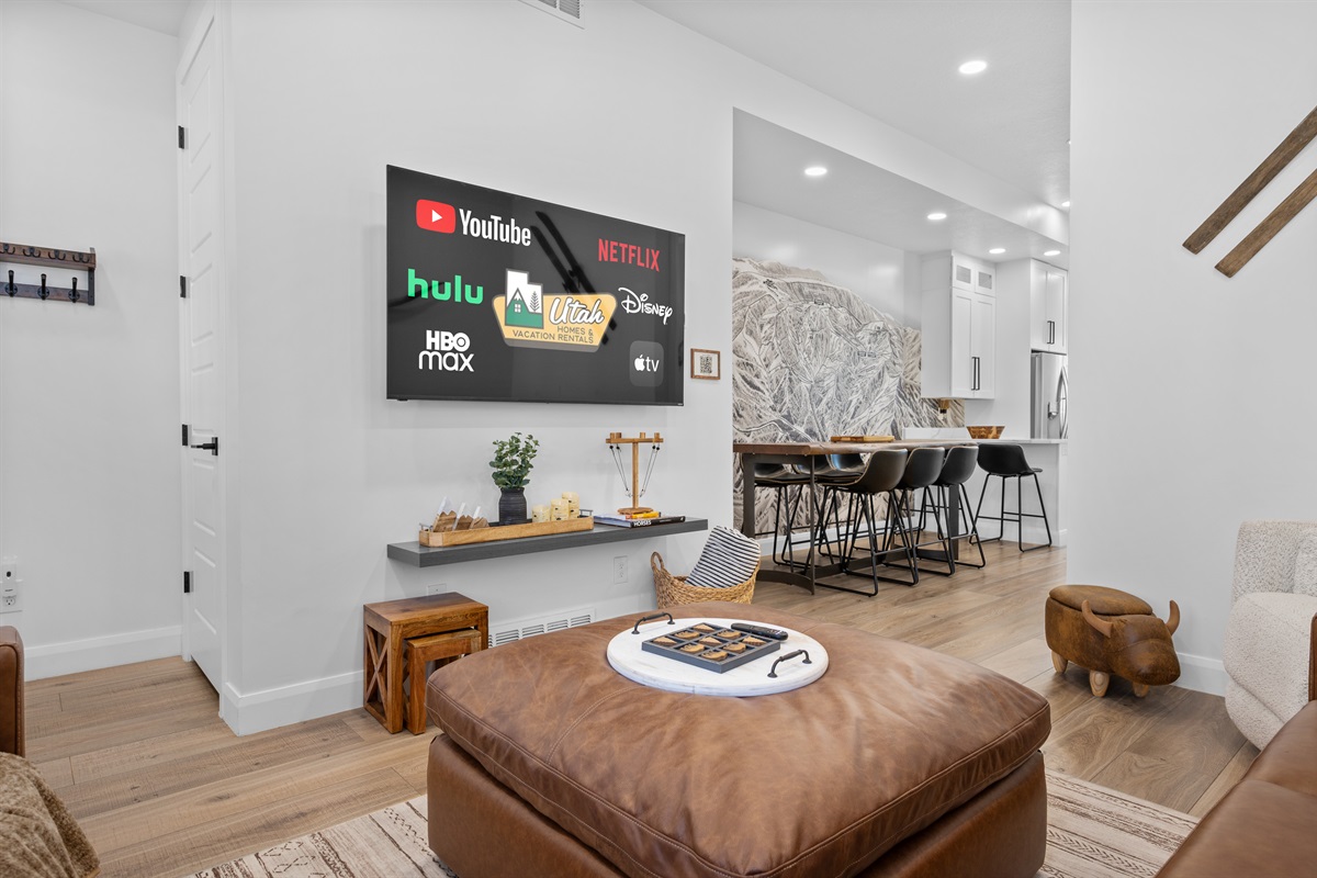 Open-concept living space with Smart TV and direct flow to dining and kitchen.