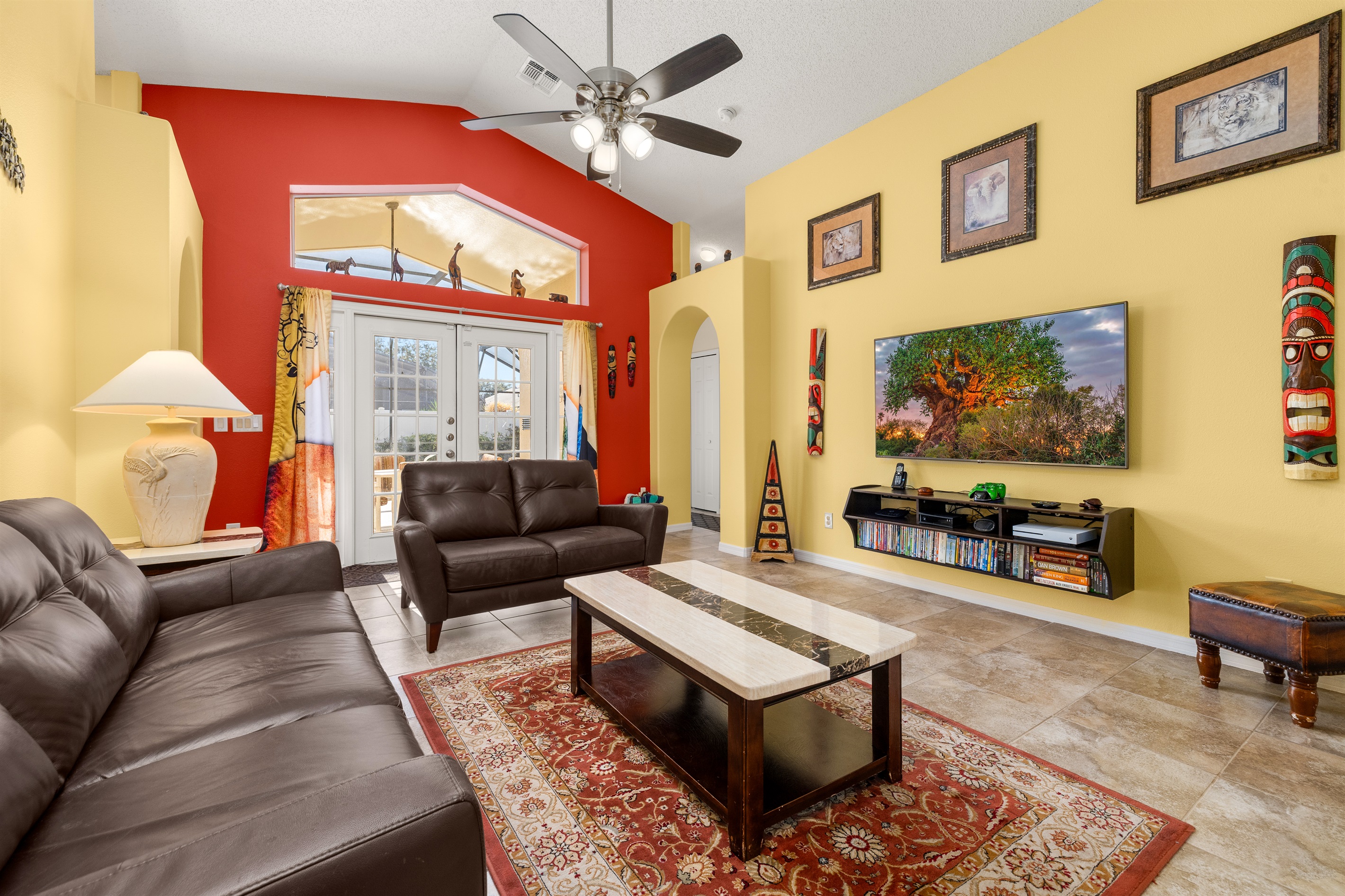 The beautiful great room is colorful, bright and open with a 65 inch TV!