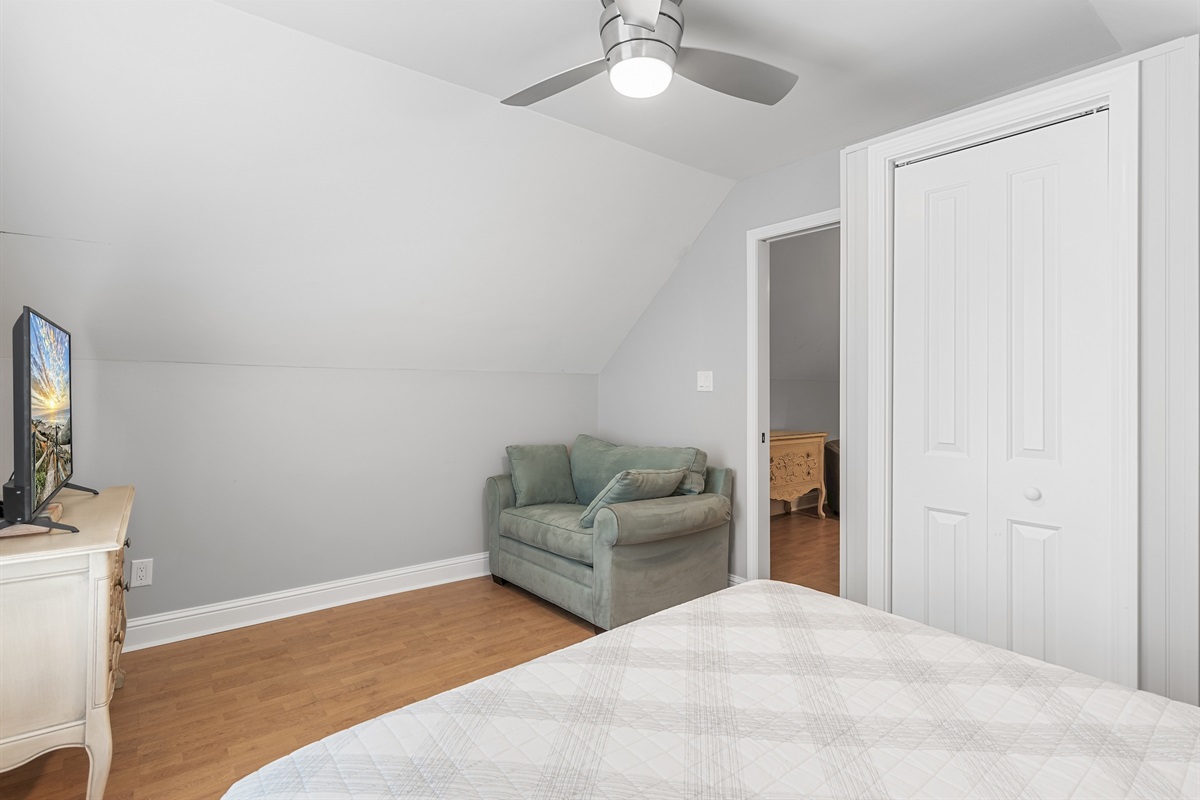 Guest bedroom with neutral décor and ample closet space