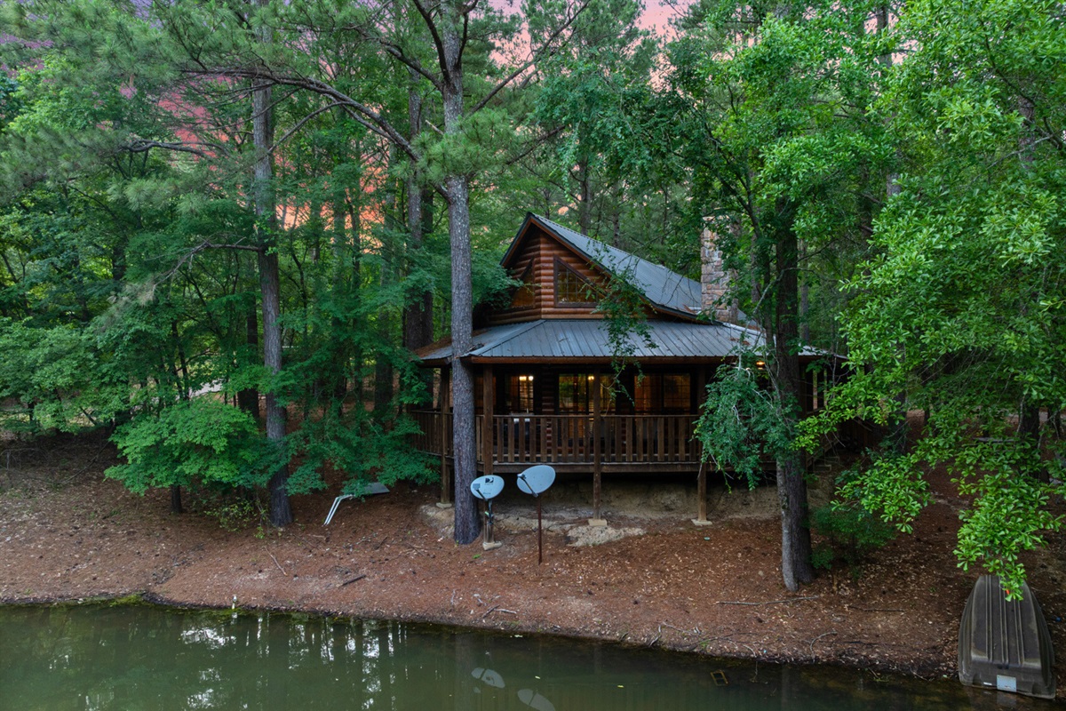 Front view of the cabin by the pond—picture perfect.