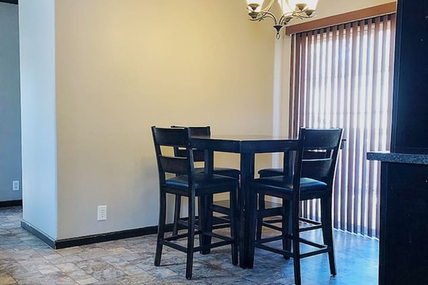 Dining room with patio door that leads to large outdoor deck. 