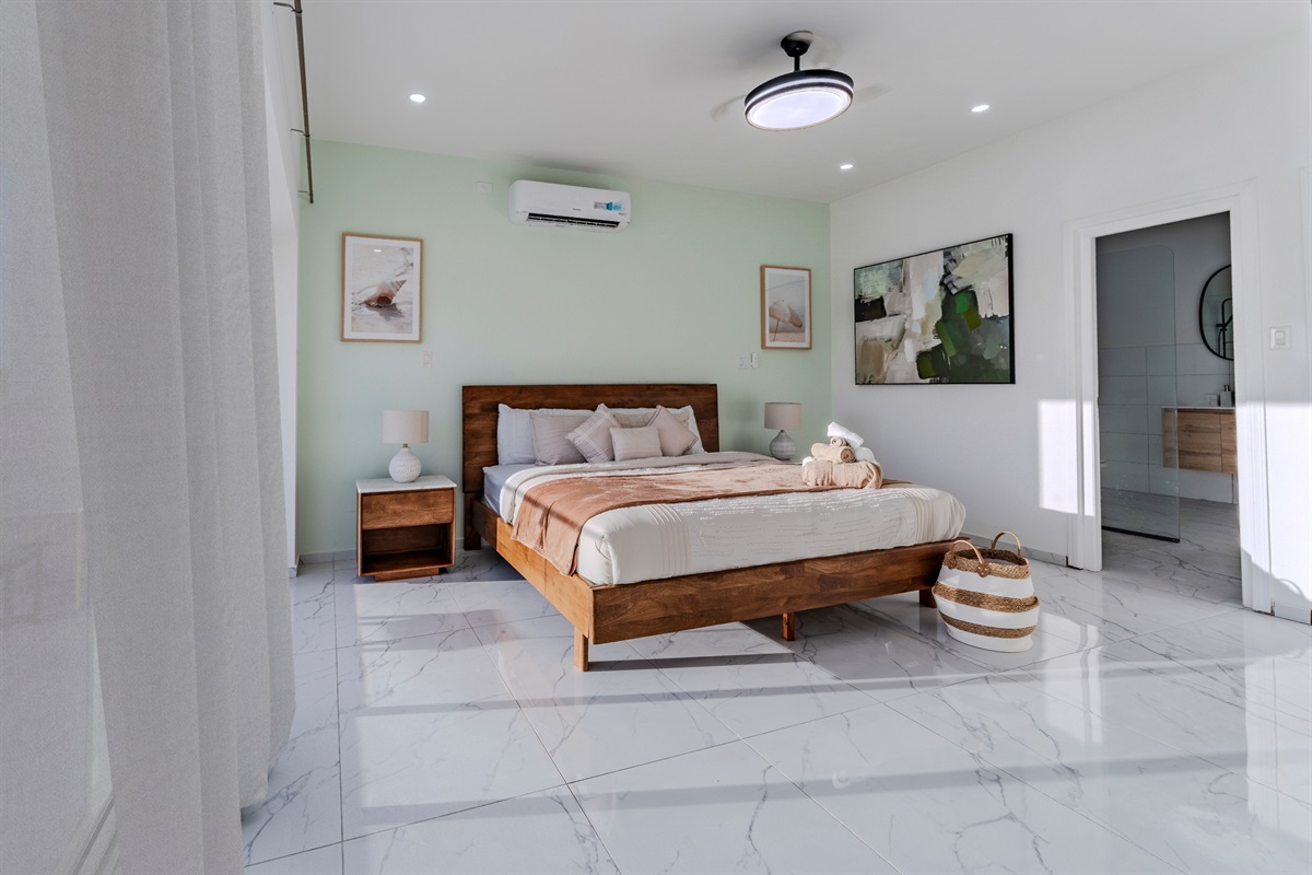 Elegant Bedroom with Plush Bedding & Sheer Floor‑to‑Ceiling Curtains