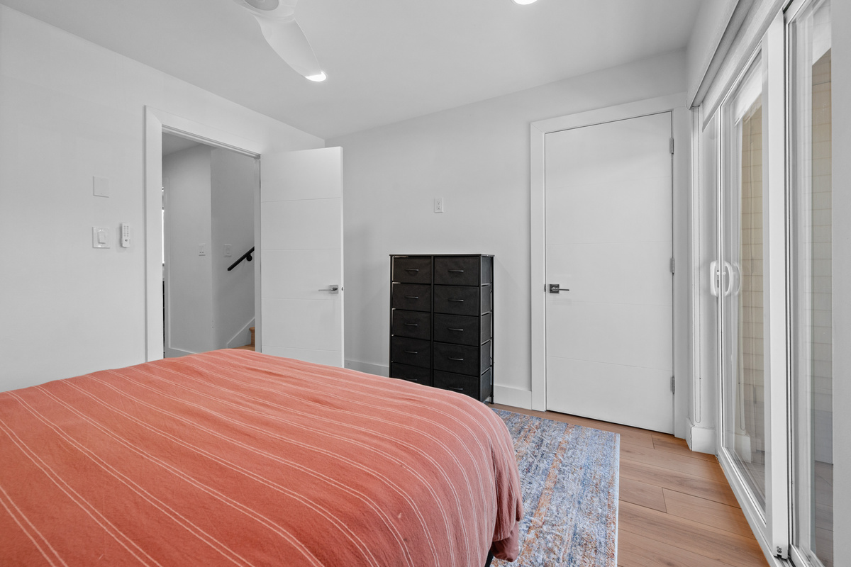 Spacious Queen bedroom with ample storage and easy access to the main-level bathroom.