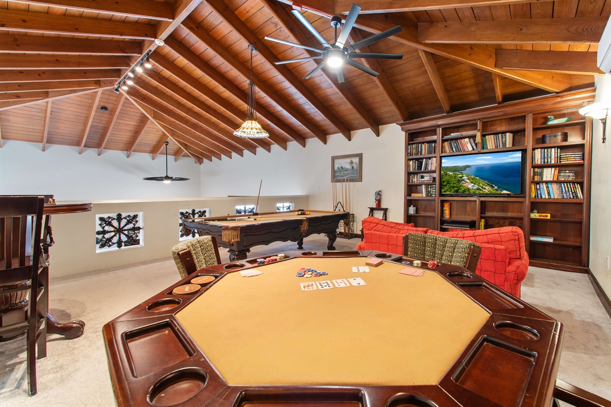 This game room is air conditioned and open to the living area below.