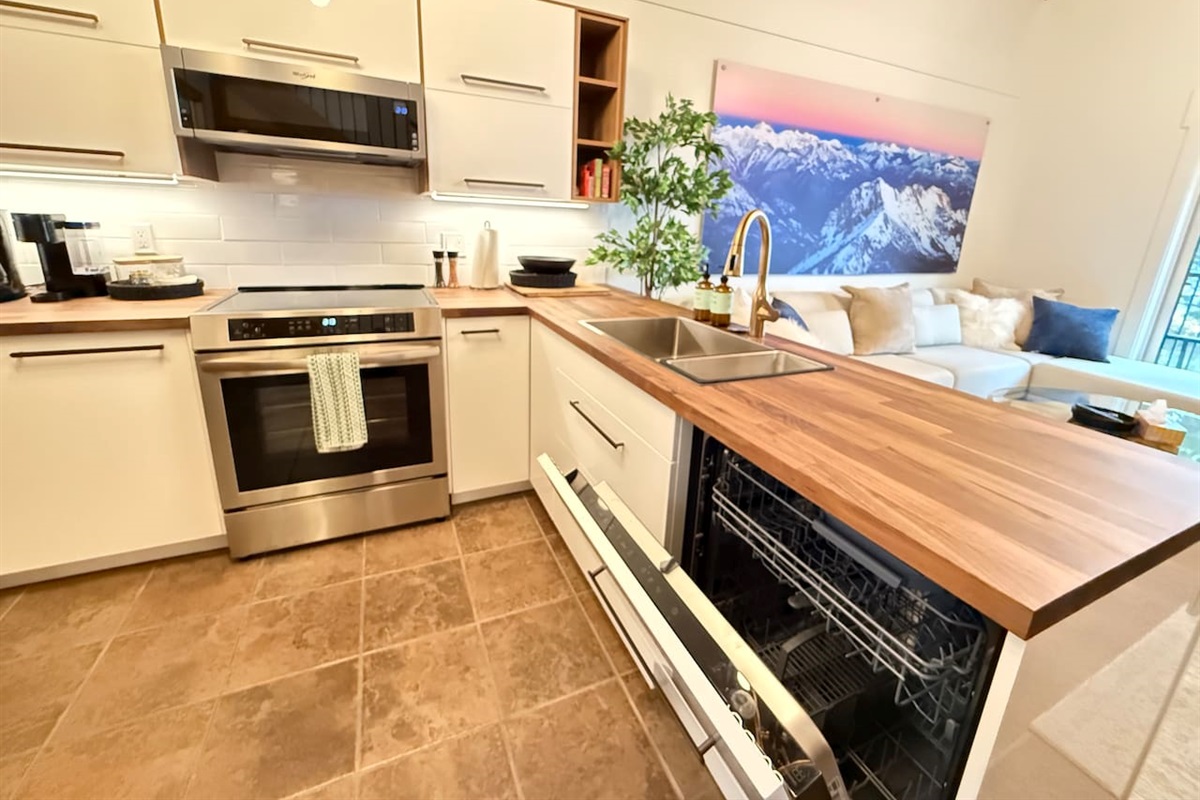 Efficient Layout: Enjoy this thoughtfully designed kitchen with a new built-in dishwasher, new microwave, and extensive countertop space for easy cooking and entertaining.