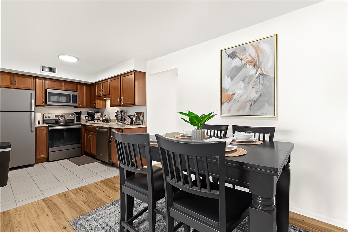 Gather around this sleek black dining table, beautifully set for your stay.
