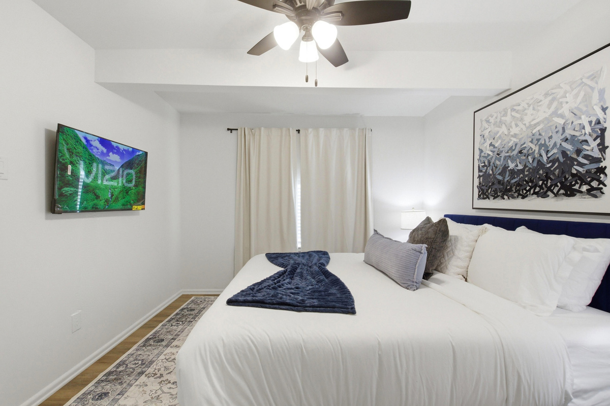 42 inch Smart TV mounted in Bedroom 1 for Streaming after a day exploring Arlington. King Bed, Ceiling Fan, and quiet evenings just minutes from Globe Life Field.
