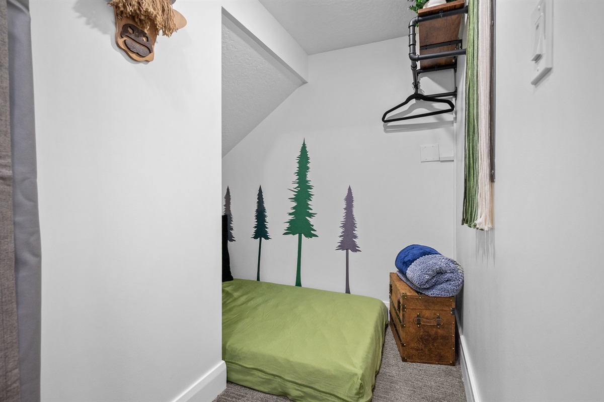 Fun “Harry Potter Bed” kids’ nook with twin mattress and themed décor.