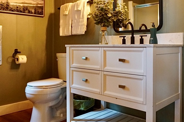 Spa-Like Bathroom: Enjoy modern fixtures and warm ambiance for a rejuvenating retreat!