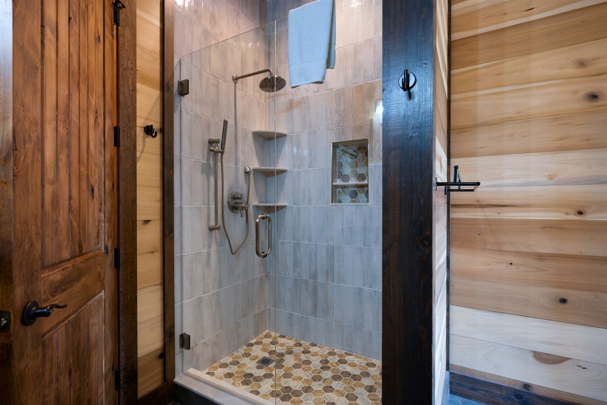 A modern shower with beautiful tile work, offering a spa-like experience.