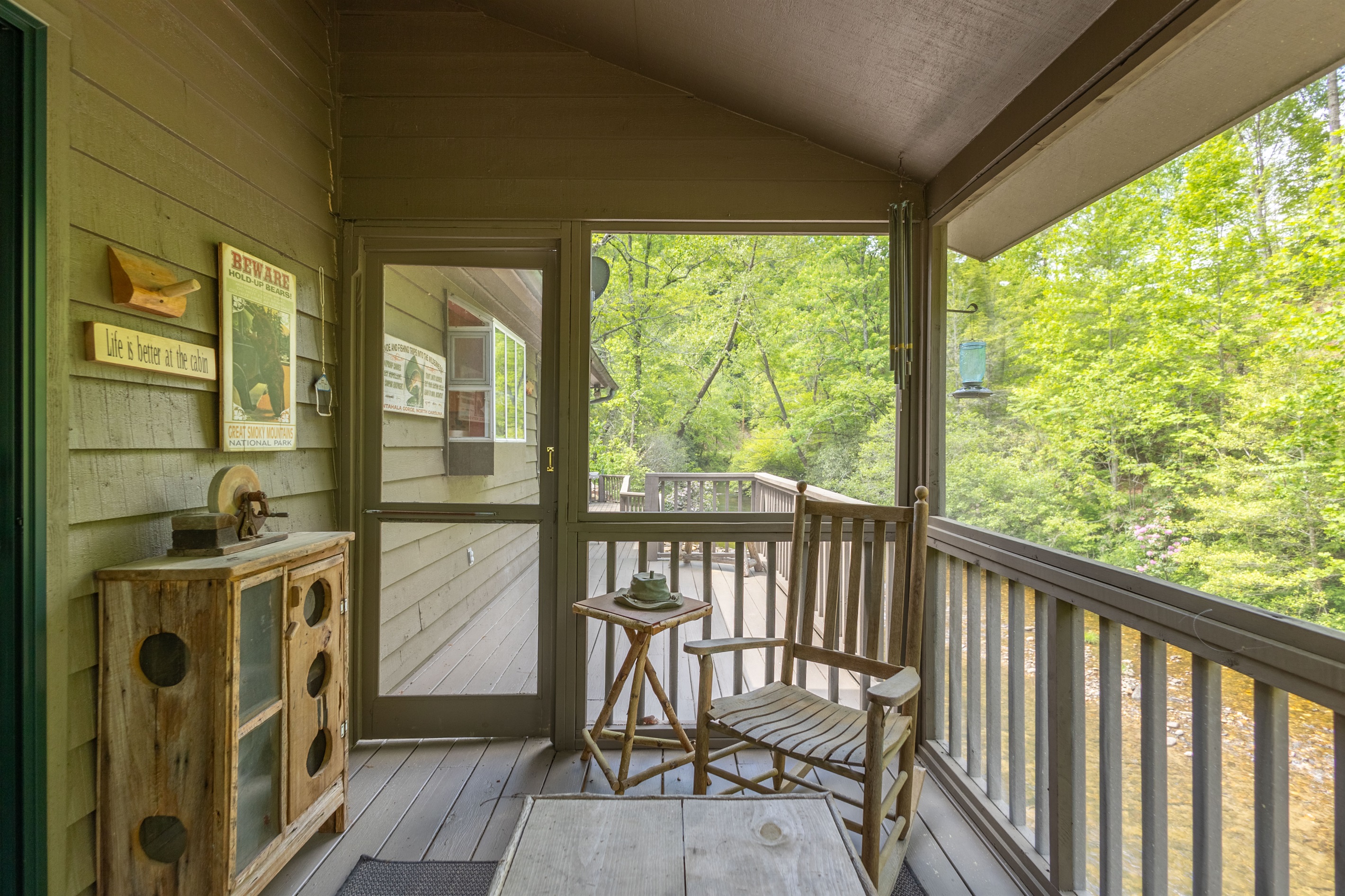 Whether you’re sipping morning coffee or winding down in the evening, the screened porch provides a cozy outdoor space surrounded by nature.