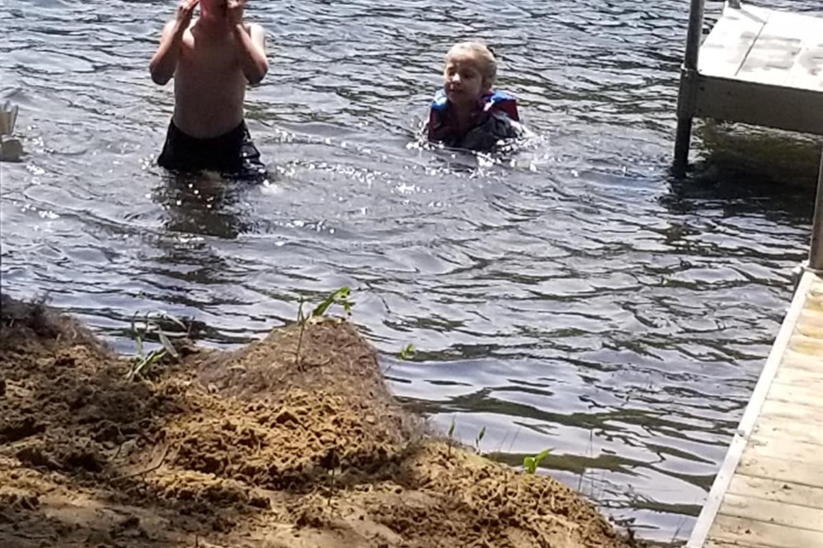 Kids love the shallow, weed-free water around the dock. Gentle shoreline makes wading, swimming, and floating safe and fun while parents relax nearby. Life jackets provided.