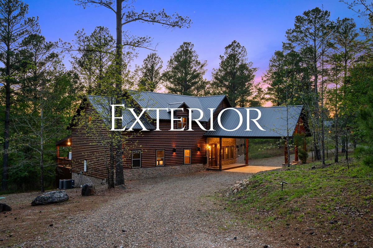 The exterior view showcases the cabin’s beautiful design nestled among tall pines, creating a peaceful and private retreat.