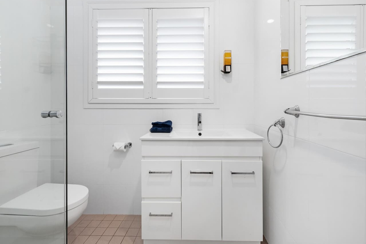 This upstairs main bathroom includes the shower and toilet for the upper level, close to the main bedrooms and living spaces.