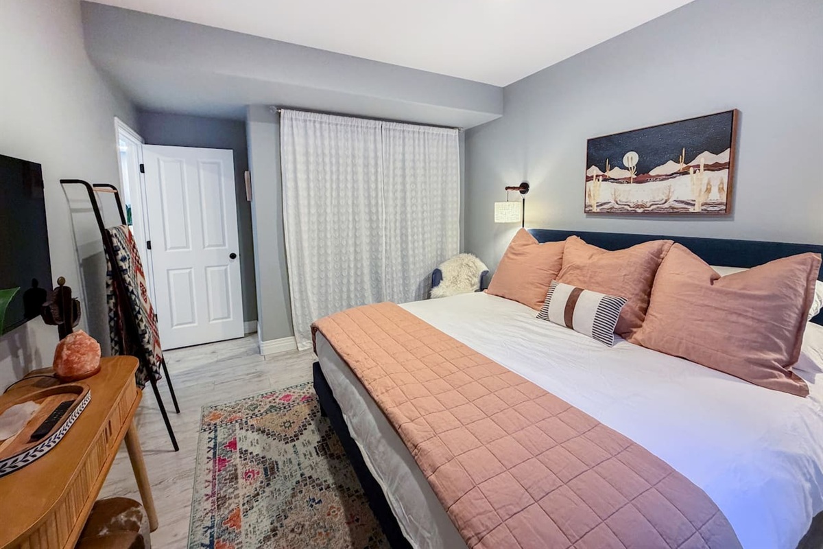 Cozy king bedroom in the entertainment area featuring soft lighting, stylish décor, and a peaceful, private retreat.