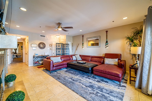 Spacious living room with comfortable sectional seating, lake-inspired decor, and access to the patio.