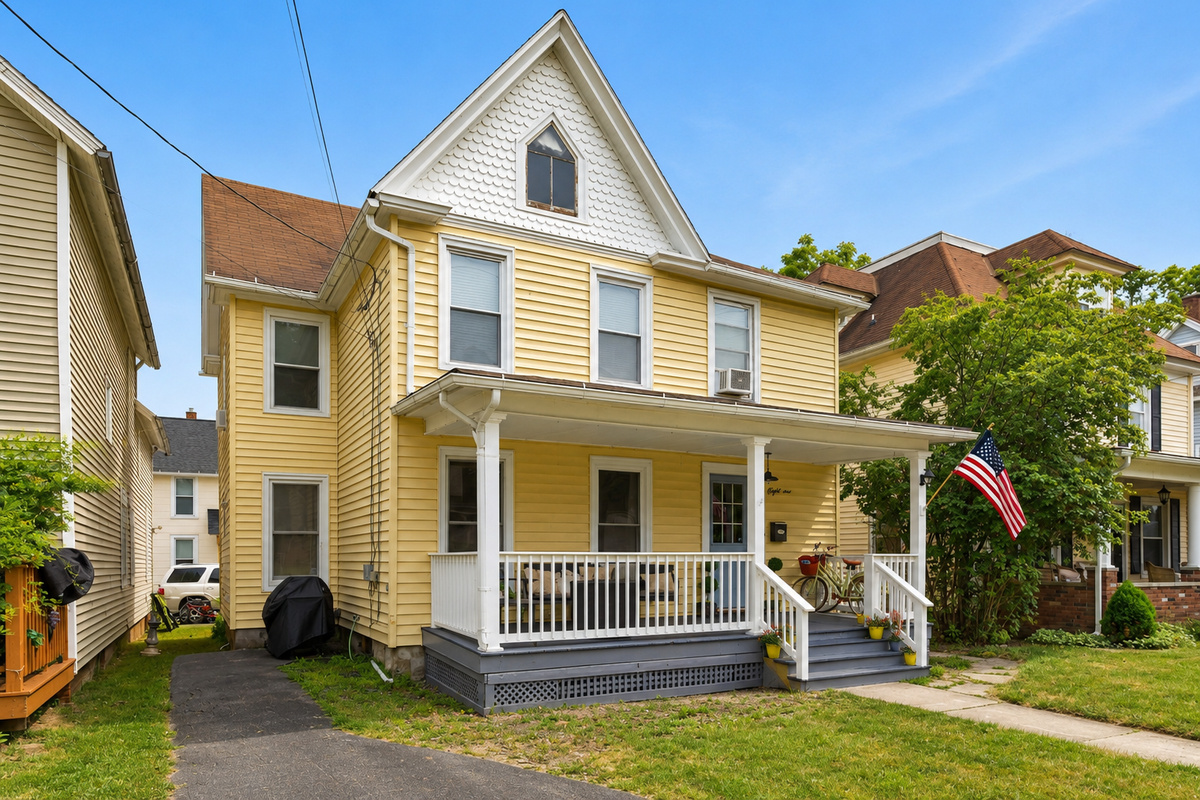 Yellow two-story home with front porch