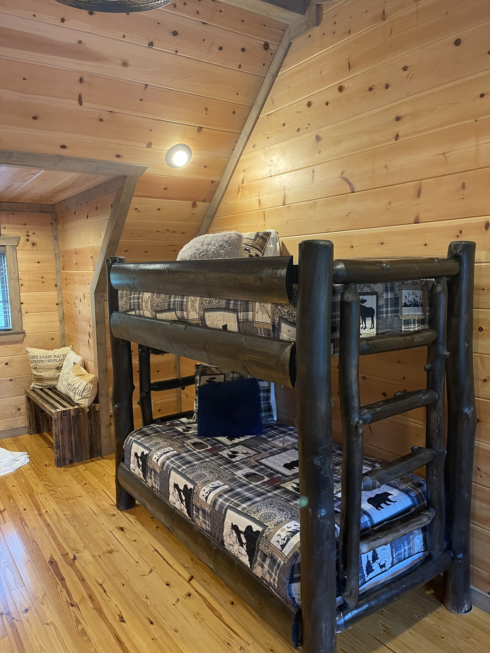 The upstairs loft area with twin bunk beds and a throw-back game console table.