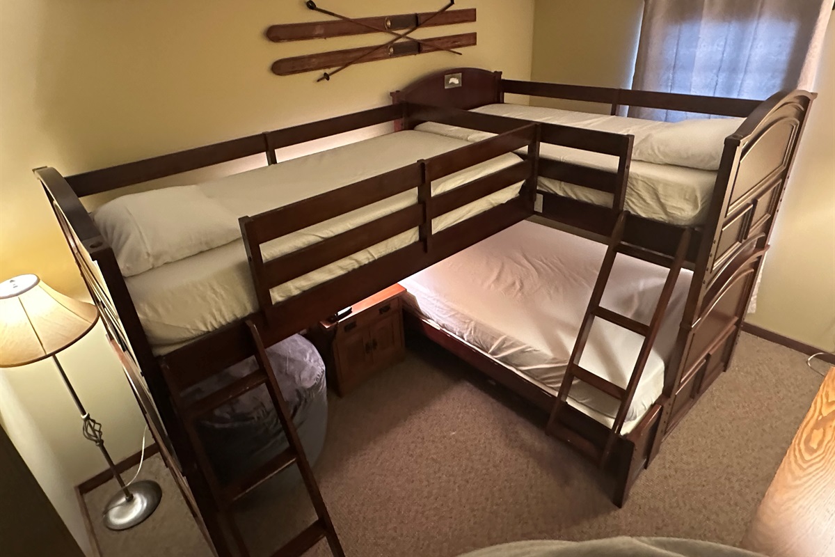 Two twin beds on top and a full bed on the bottom
