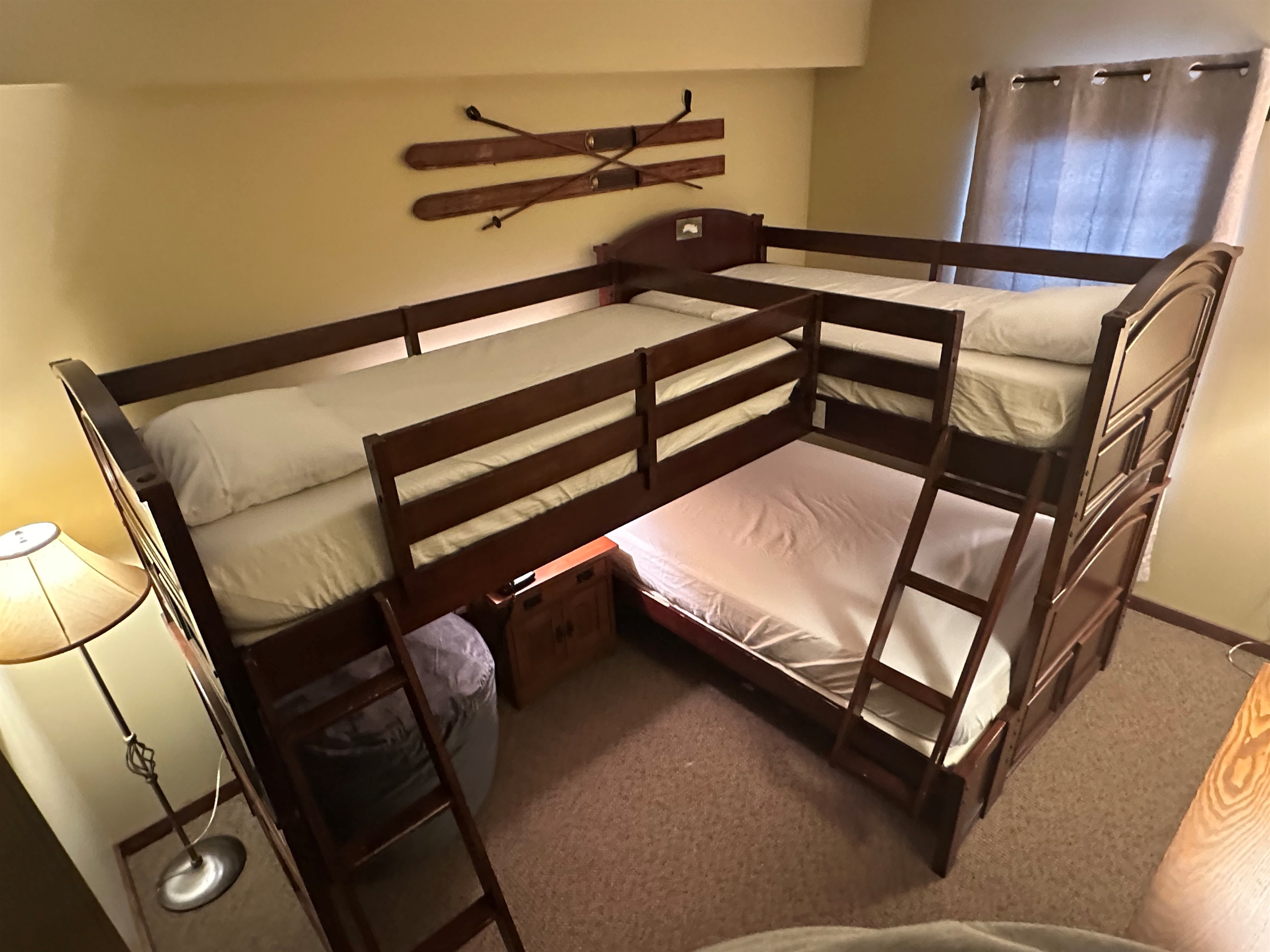 Two twin beds on top and a full bed on the bottom