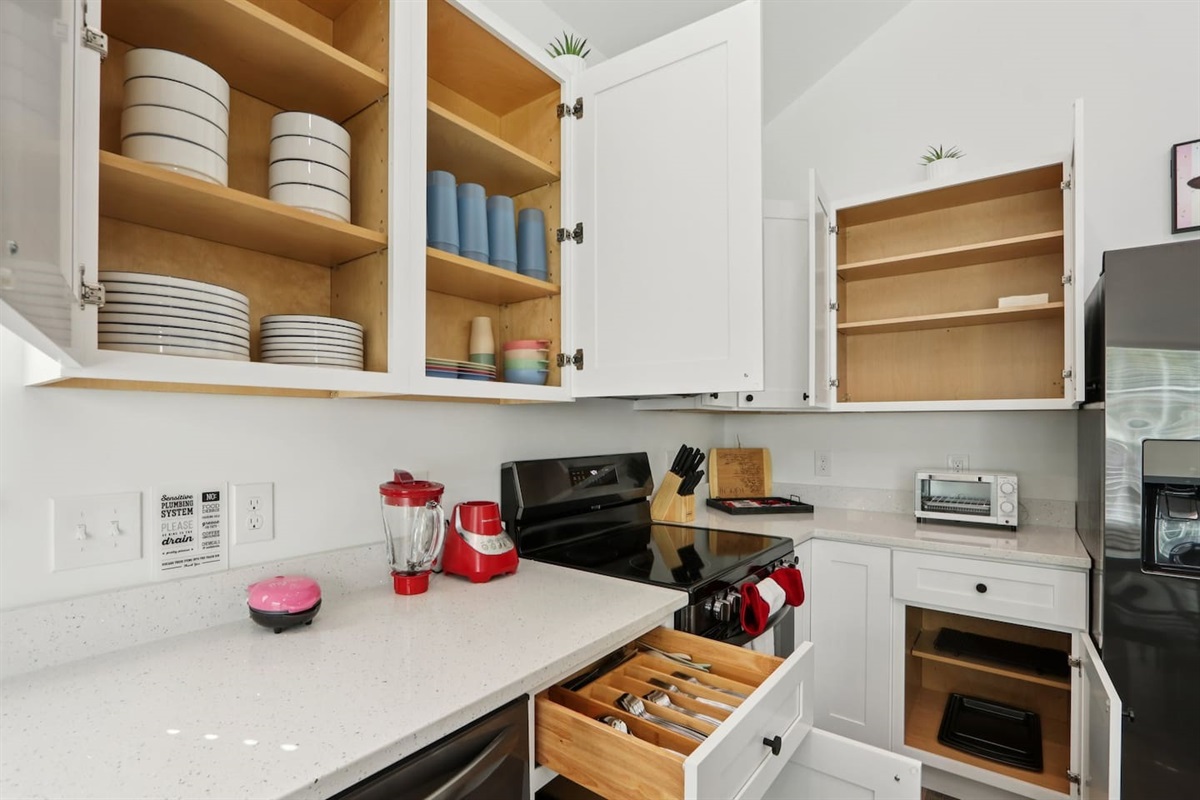 Coffee mugs with Keurig coffee maker (pods included), hot water heater, mini waffle maker, blender, stove, oven, dishwasher, fridge, filtered water, knives, cutting board, pots/pans, baking sheets, utensils.  