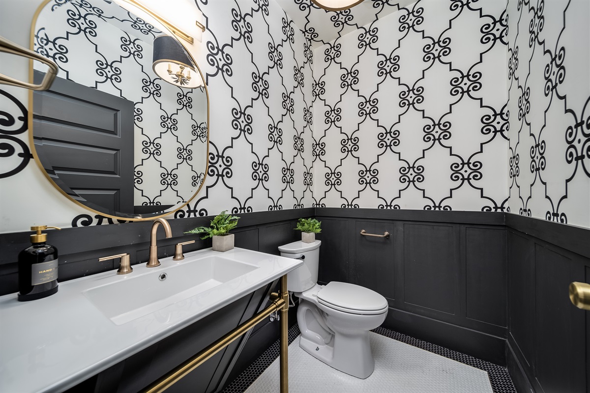 Enjoy the added ease of a well-appointed half-bathroom, thoughtfully placed for quick access